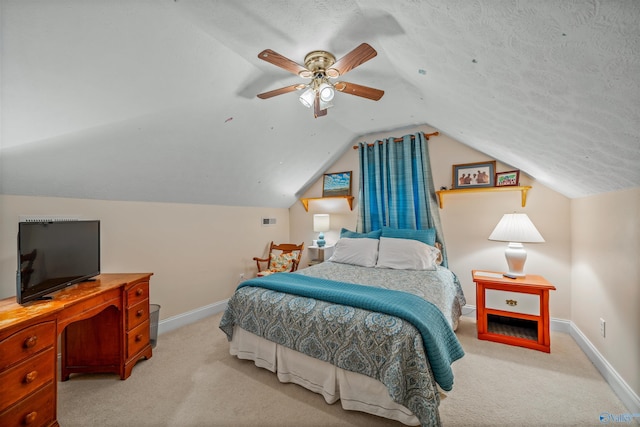 carpeted bedroom with ceiling fan, a textured ceiling, baseboards, and vaulted ceiling