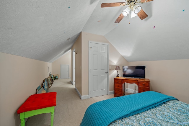 carpeted bedroom with baseboards, a textured ceiling, lofted ceiling, and ceiling fan