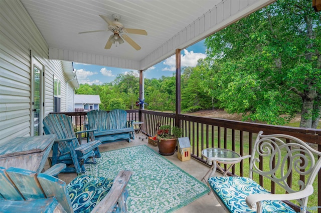 wooden deck featuring ceiling fan