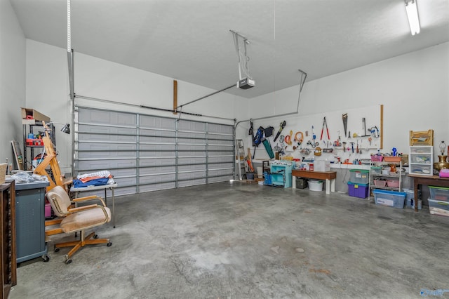 garage with a workshop area and a garage door opener