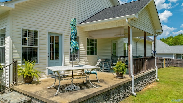 wooden terrace with a patio area and a lawn