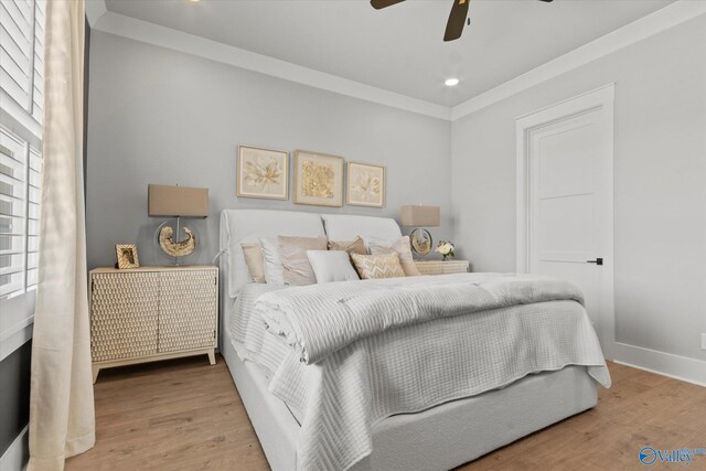 bedroom with ceiling fan, radiator heating unit, light hardwood / wood-style floors, and ornamental molding