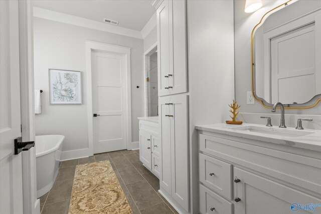 bathroom with tile patterned flooring, vanity, and a bathing tub