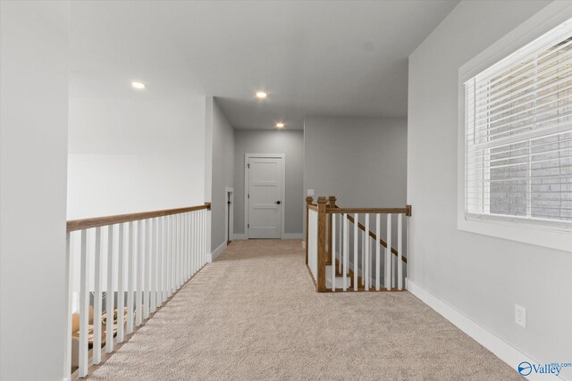 hallway featuring light carpet