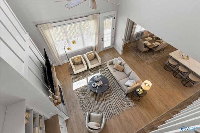 living room featuring ceiling fan and light wood-type flooring