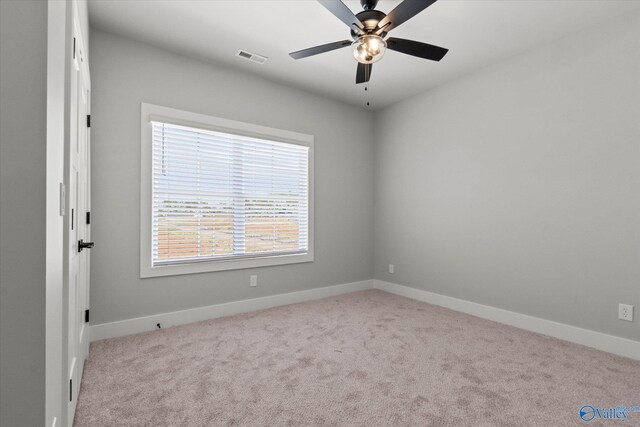 empty room featuring carpet flooring and ceiling fan