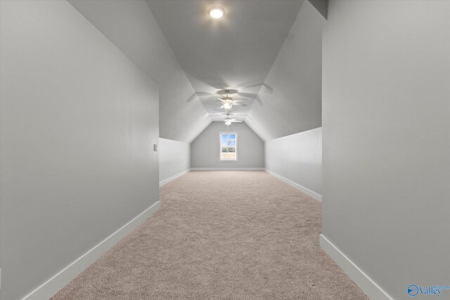 additional living space with light carpet, lofted ceiling, and ceiling fan