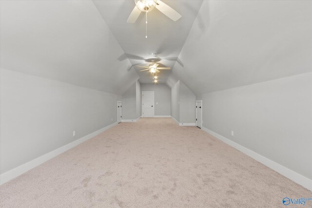 bonus room featuring lofted ceiling, ceiling fan, and light colored carpet