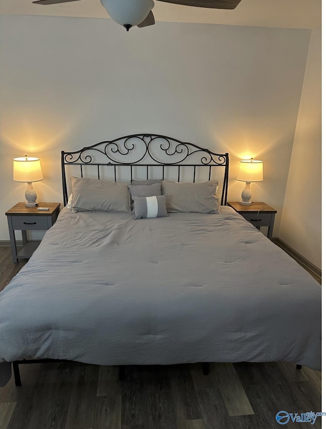 bedroom with dark wood-type flooring