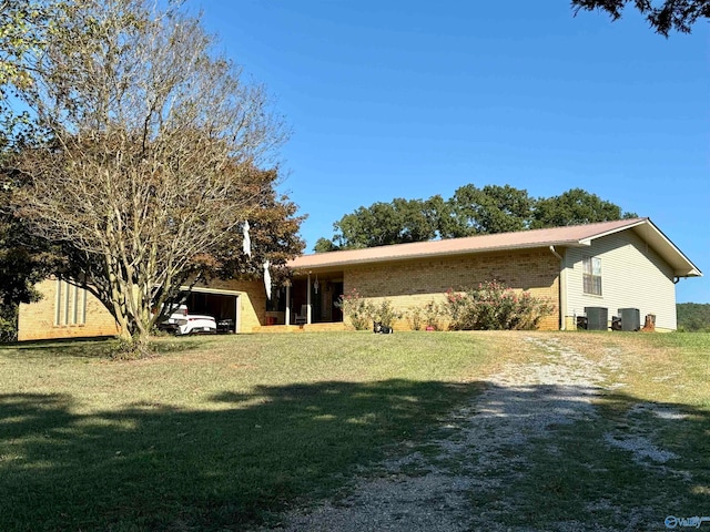 view of front of property with cooling unit and a front lawn