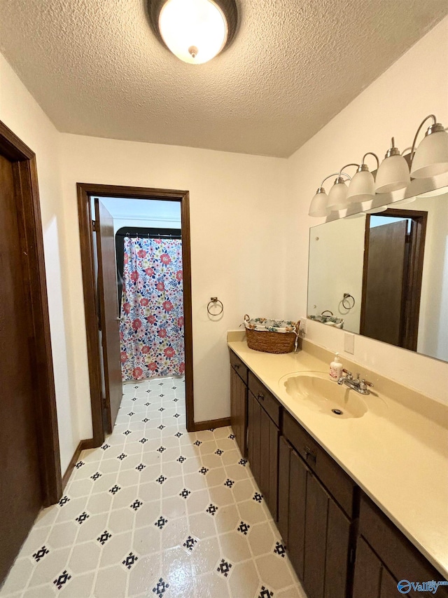 bathroom with vanity, a textured ceiling, and a shower with shower curtain