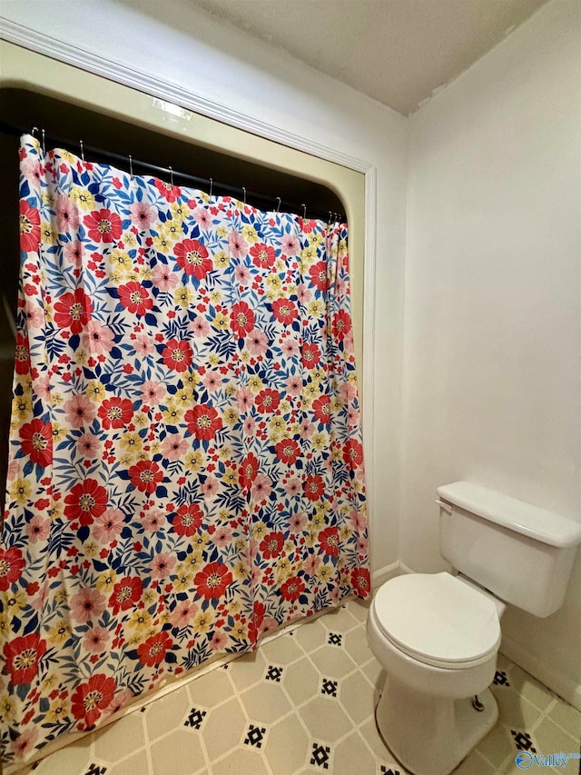 bathroom with toilet and a textured ceiling