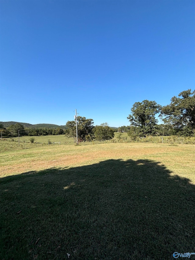 view of yard with a rural view