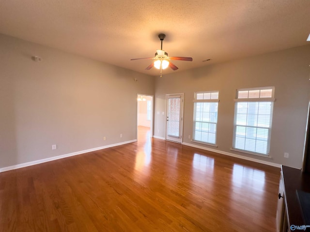 spare room with ceiling fan, wood-type flooring, and a textured ceiling