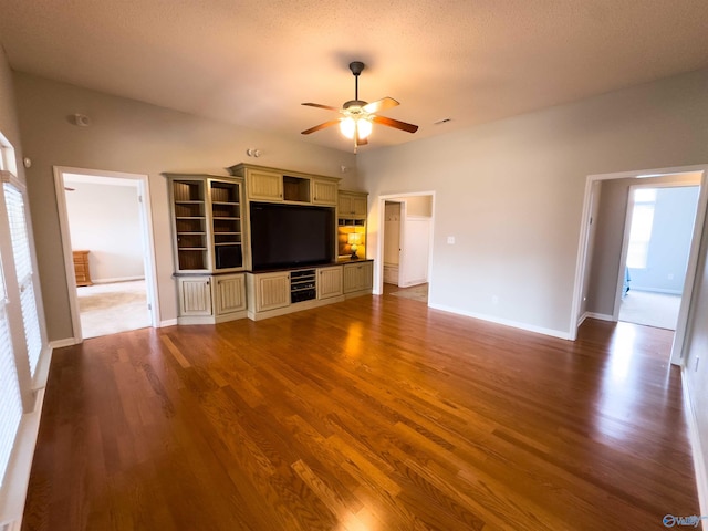 unfurnished living room featuring ceiling fan and wood-type flooring