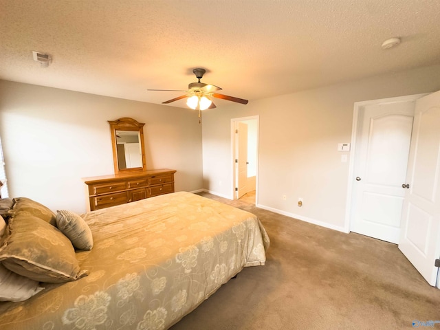 bedroom featuring a textured ceiling, carpet flooring, and ceiling fan