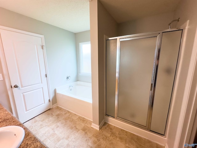 bathroom with sink, a textured ceiling, tile patterned floors, and independent shower and bath