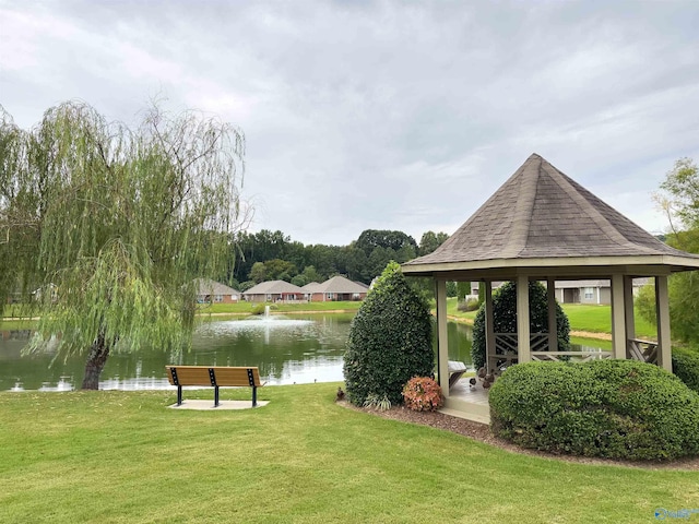 surrounding community with a water view, a gazebo, and a yard