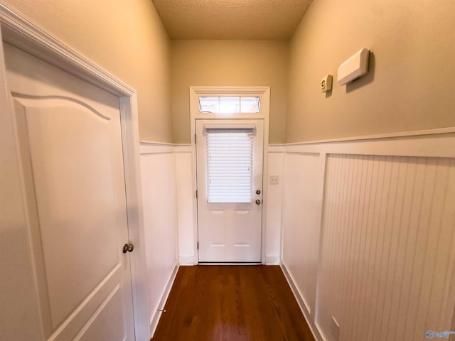 entryway with dark hardwood / wood-style flooring and a textured ceiling