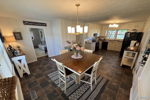 403 Taylor Rd, Glencoe, AL 35905 - dining room with a chandelier and a textured ceiling