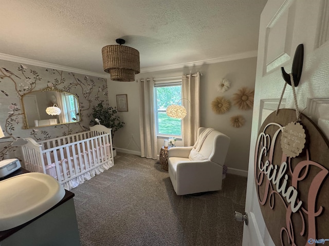 403 Taylor Rd, Glencoe, AL 35905 - carpeted bedroom featuring ornamental molding, baseboards, a textured ceiling, a nursery area, and wallpapered walls