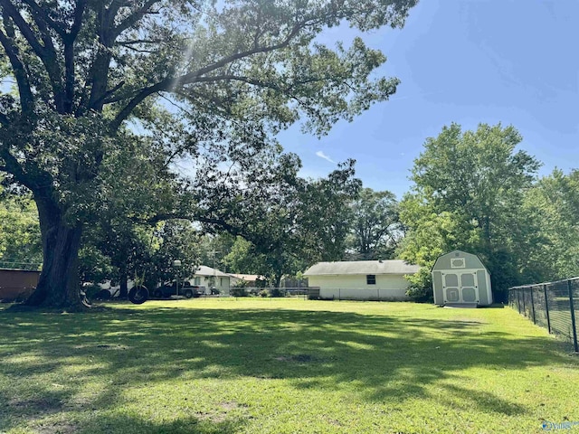 403 Taylor Rd, Glencoe, AL 35905 - view of yard with a storage shed, an outdoor structure, and view of wooded area