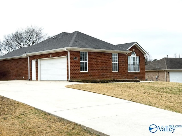 view of side of home with a yard and a garage