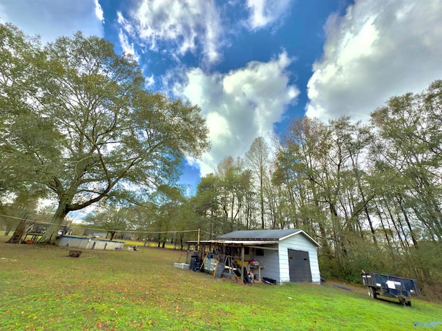 view of yard featuring an outbuilding and a detached garage