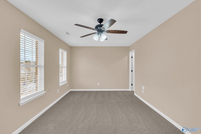 unfurnished room featuring ceiling fan and carpet