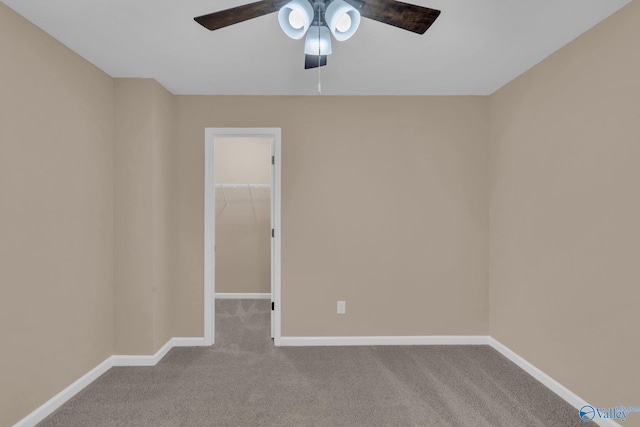 spare room with ceiling fan and light colored carpet