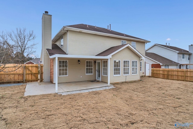 back of house with a patio area and a yard