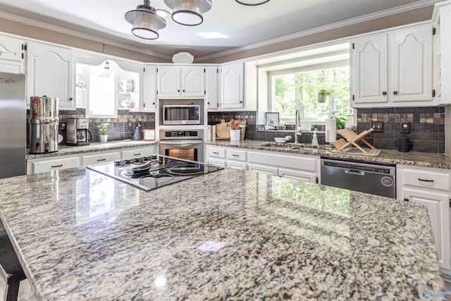 kitchen with stainless steel appliances, a sink, white cabinetry, ornamental molding, and light stone countertops