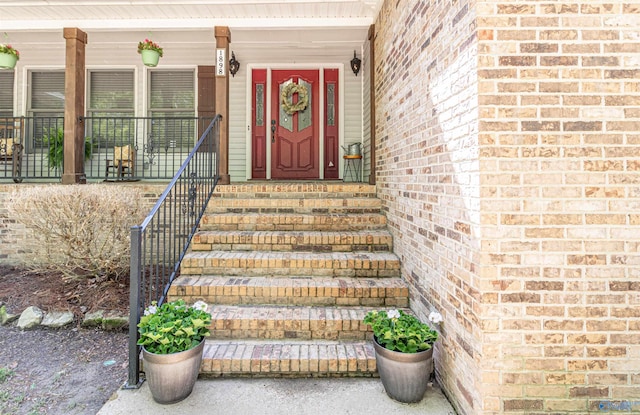 doorway to property with brick siding