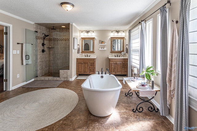 bathroom with a textured ceiling, vanity, a soaking tub, a shower stall, and crown molding