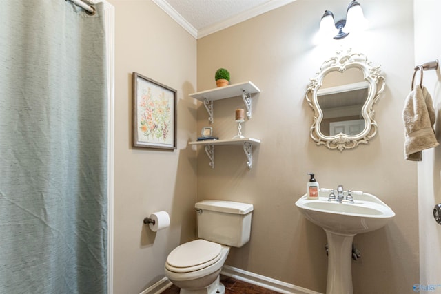 bathroom featuring ornamental molding, toilet, and baseboards