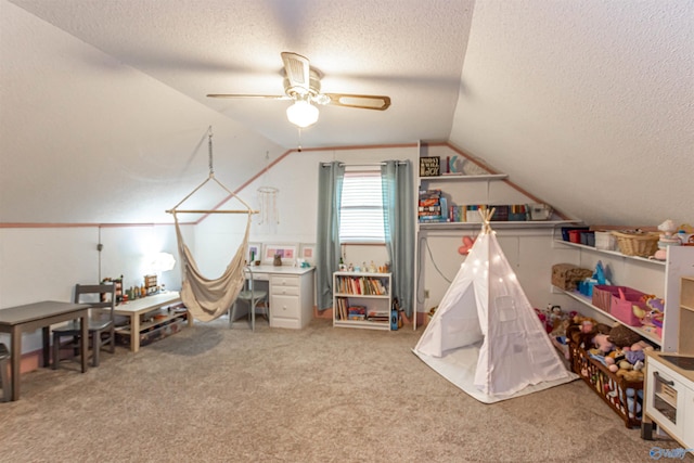 game room featuring lofted ceiling, ceiling fan, light carpet, and a textured ceiling