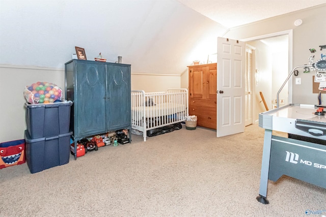 bedroom with a nursery area, light carpet, and vaulted ceiling