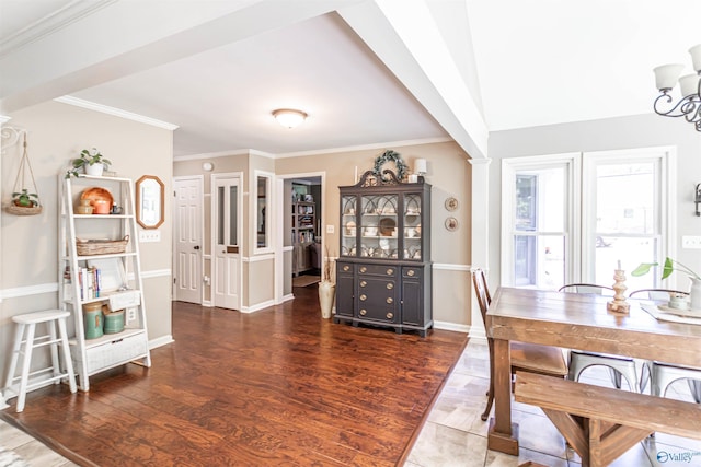 dining area featuring ornamental molding, dark wood-type flooring, and baseboards