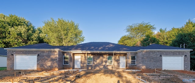 ranch-style home with a garage and brick siding