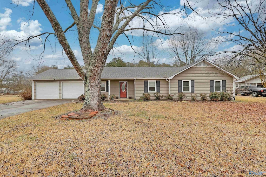 ranch-style home with a garage and a front yard