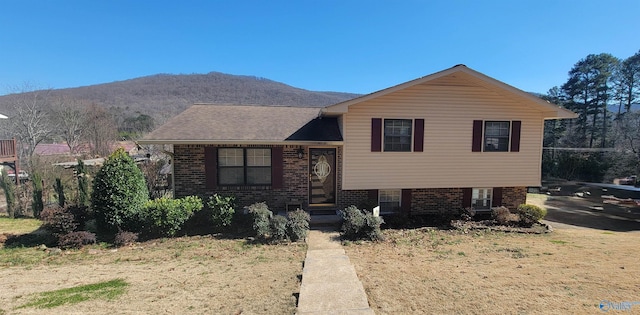 tri-level home with brick siding and a mountain view