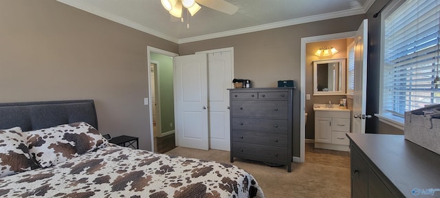 bedroom with light carpet, a sink, a ceiling fan, ornamental molding, and ensuite bath