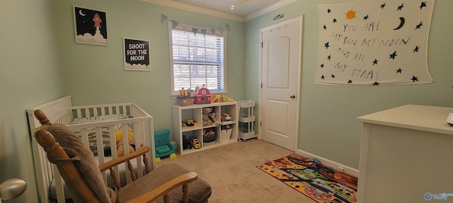 bedroom with light carpet, baseboards, crown molding, and a crib