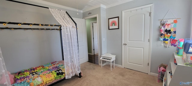 bedroom featuring crown molding, baseboards, and light colored carpet