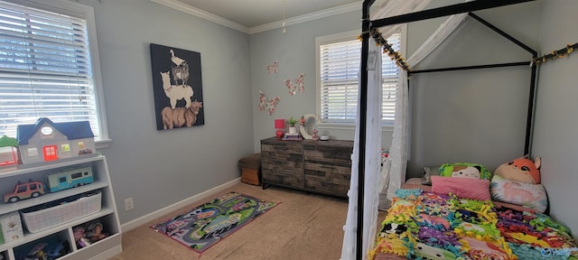 bedroom with carpet floors, crown molding, and baseboards