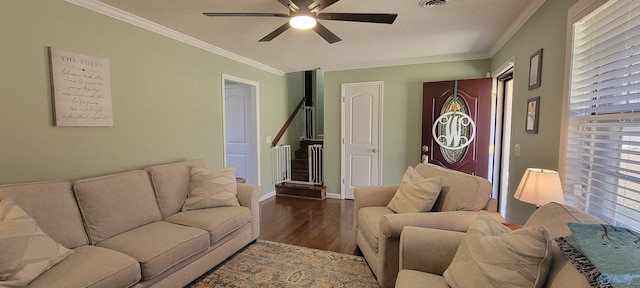 living room featuring dark wood-style floors, ceiling fan, ornamental molding, and baseboards