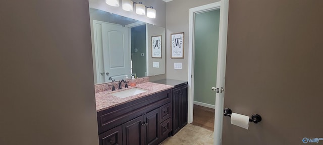 bathroom with vanity and baseboards