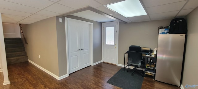 home office featuring baseboards, a drop ceiling, and dark wood-style flooring