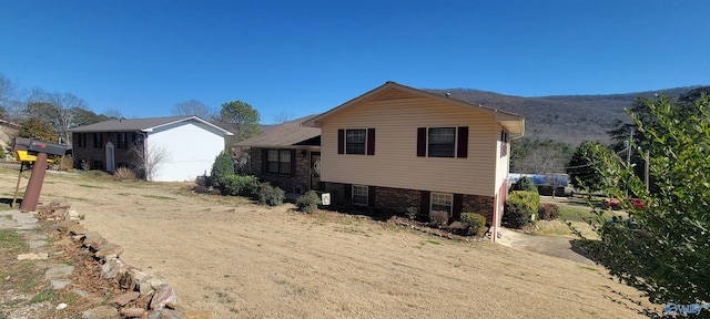 exterior space with a mountain view and brick siding