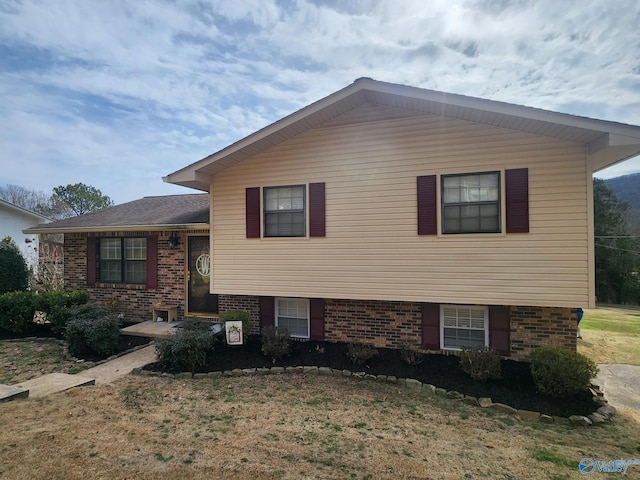 tri-level home with brick siding